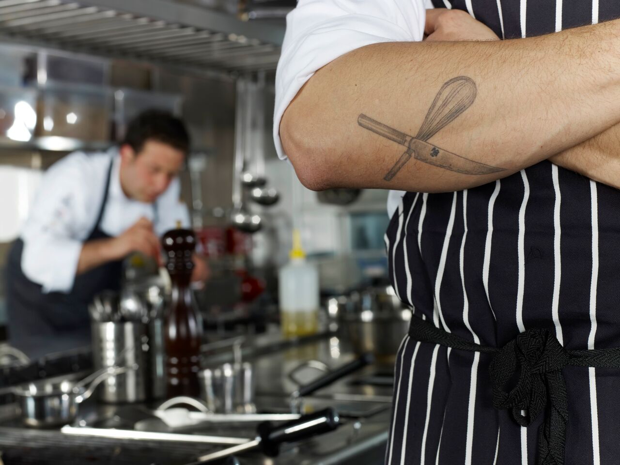 tough looking chef with whisk tattoo
